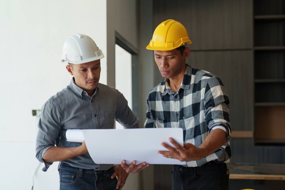 Two structural engineers comparing earthquake safety fasteners