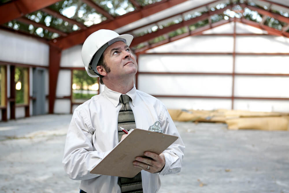 A structural engineer reviewing building codes with earthquake safety fasteners
